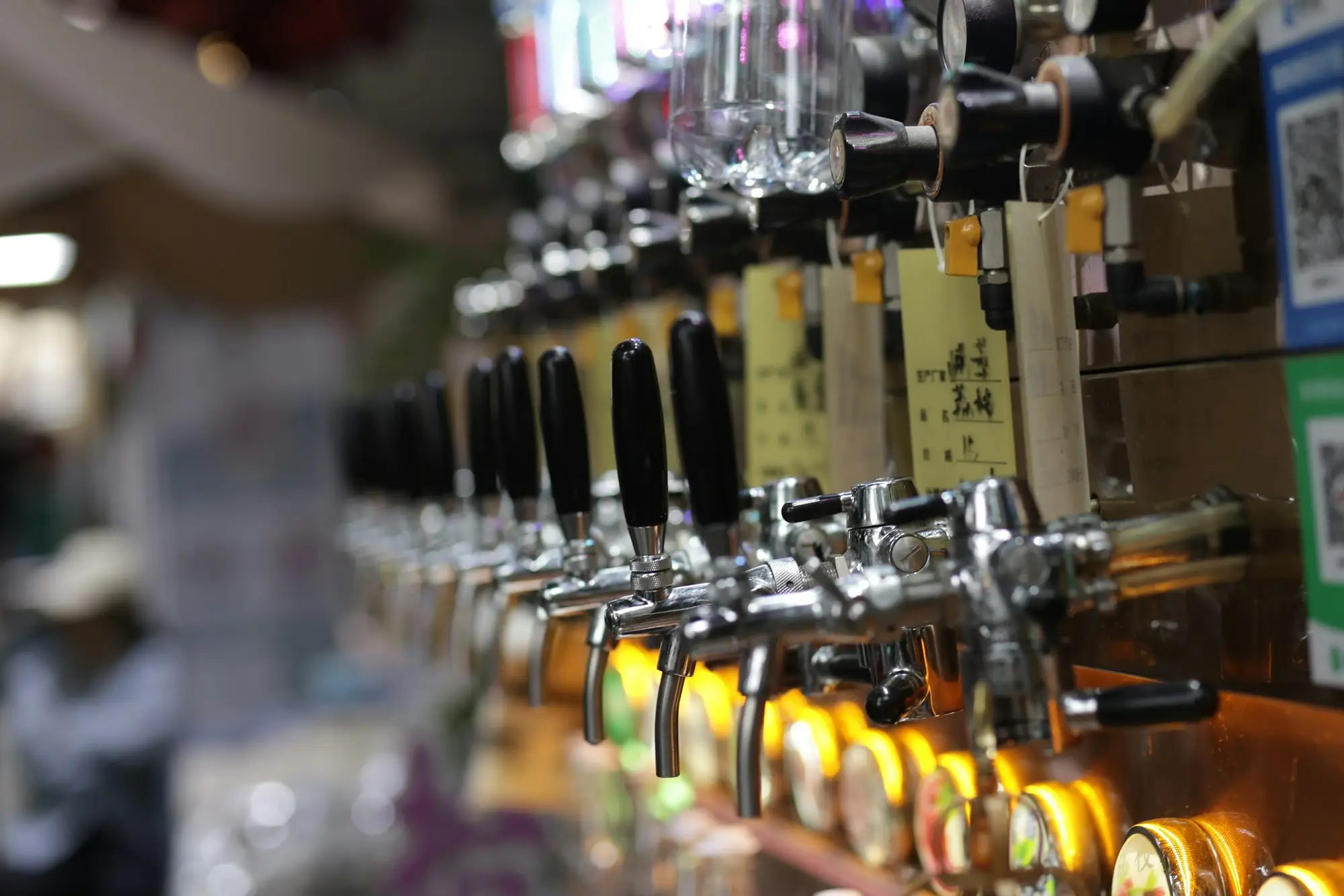 Row of chrome beer taps behind a bar, the kind of hospitality business that keeps paying wages over a Christmas shutdown